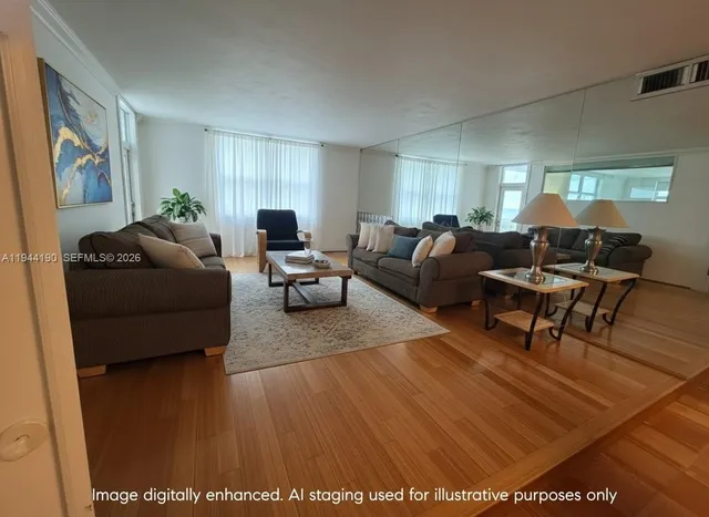 a living room with furniture and a wooden floor