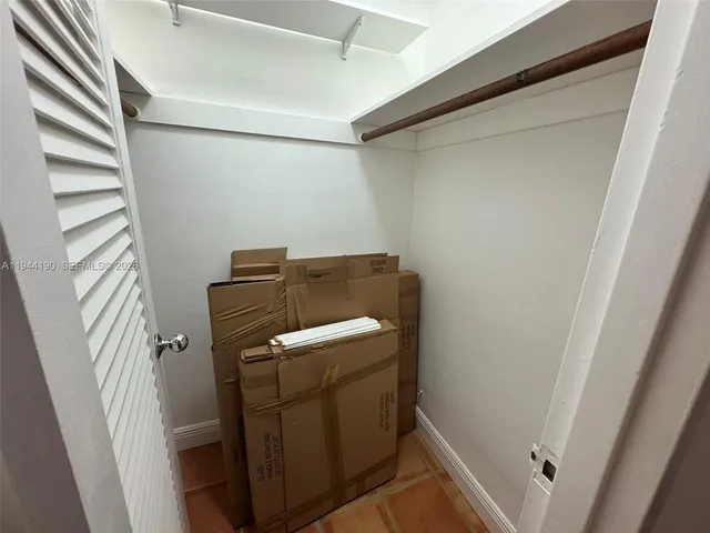 a spacious bedroom with a bed and a window