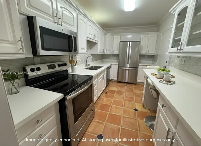 a kitchen with a sink stove and microwave