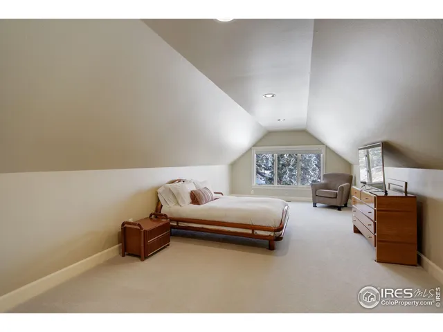 a bedroom with furniture and a lamp