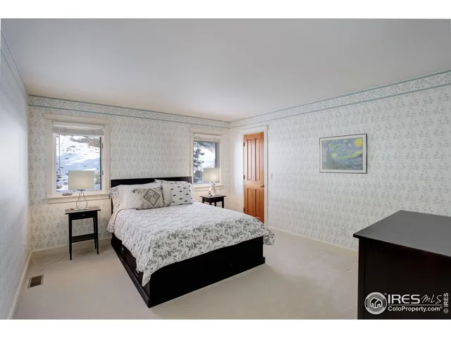 a bedroom with a bed and a table