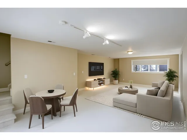 a living room with furniture a flat screen tv and a table