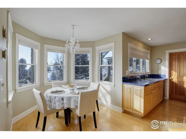 a kitchen with stainless steel appliances granite countertop a stove a sink dishwasher a dining table and chairs