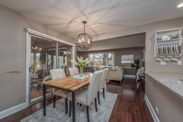 a view of a dining room with furniture wooden floor and chandelier