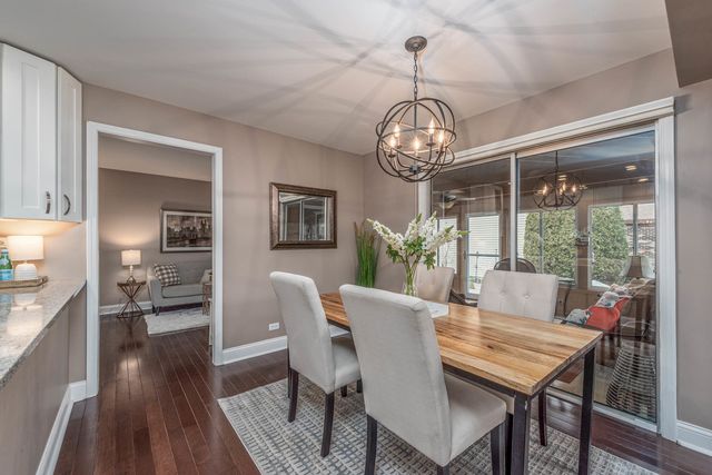 a view of a dining room with furniture wooden floor and chandelier