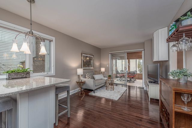 a living room with furniture wooden floor and a chandelier