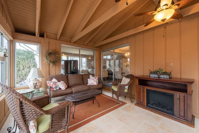 a living room with furniture a table and chairs