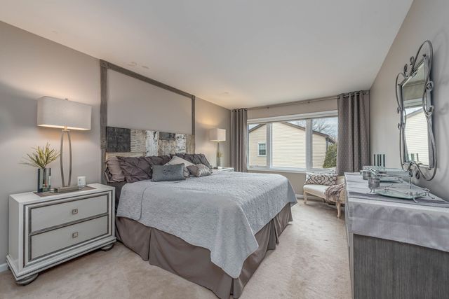 a bedroom with a bed and a lamp