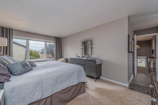 a bedroom with a bed and a dresser