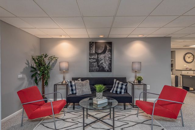 a living room with furniture and a potted plant