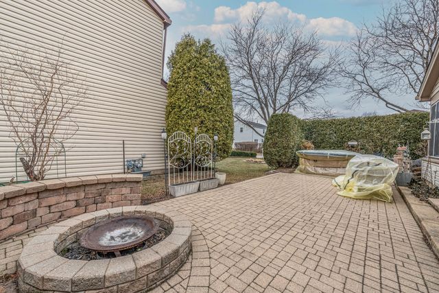 a view of a chair and fire pit in the patio