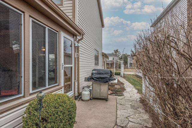 a view of a chair and fire pit in backyard of the house