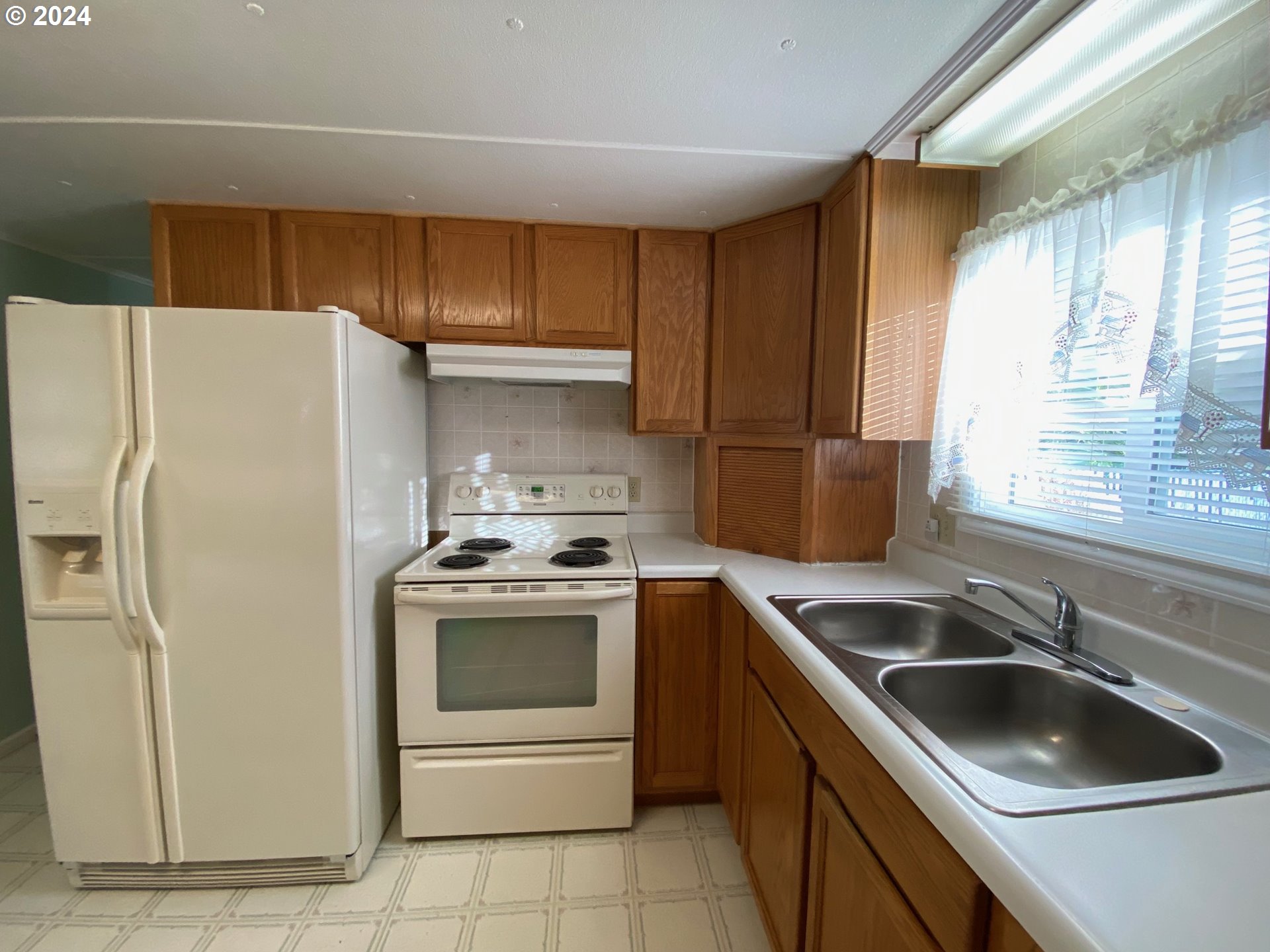 3950 Coburg Road, Unit 82 Eugene, OR 97408 - Photo 11 of 22 a kitchen with a stove sink and refrigerator