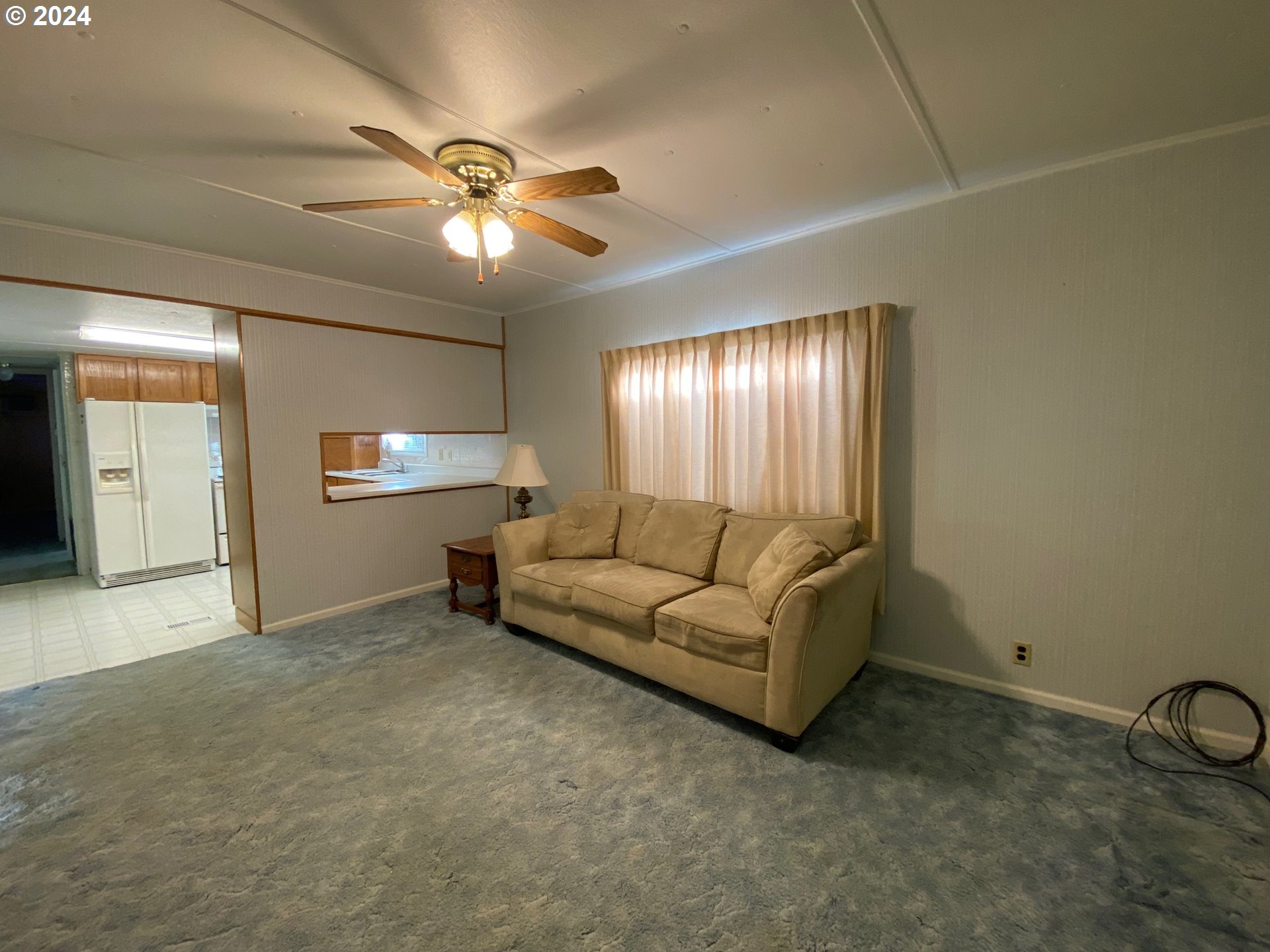 3950 Coburg Road, Unit 82 Eugene, OR 97408 - Photo 12 of 22 a living room with furniture and a chandelier