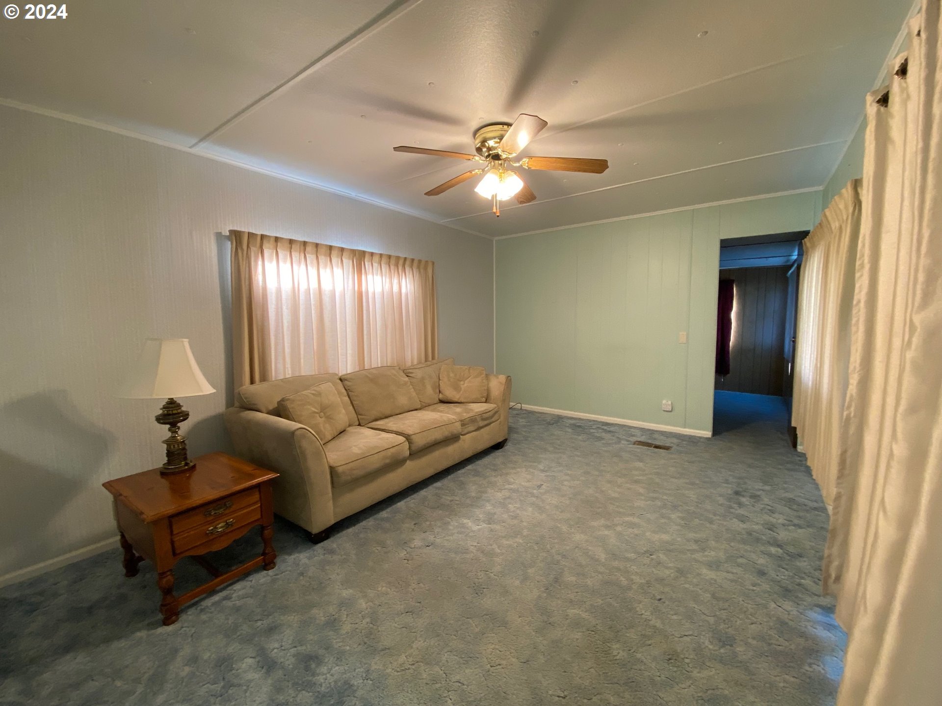 3950 Coburg Road, Unit 82 Eugene, OR 97408 - Photo 13 of 22 a living room with furniture and a ceiling fan