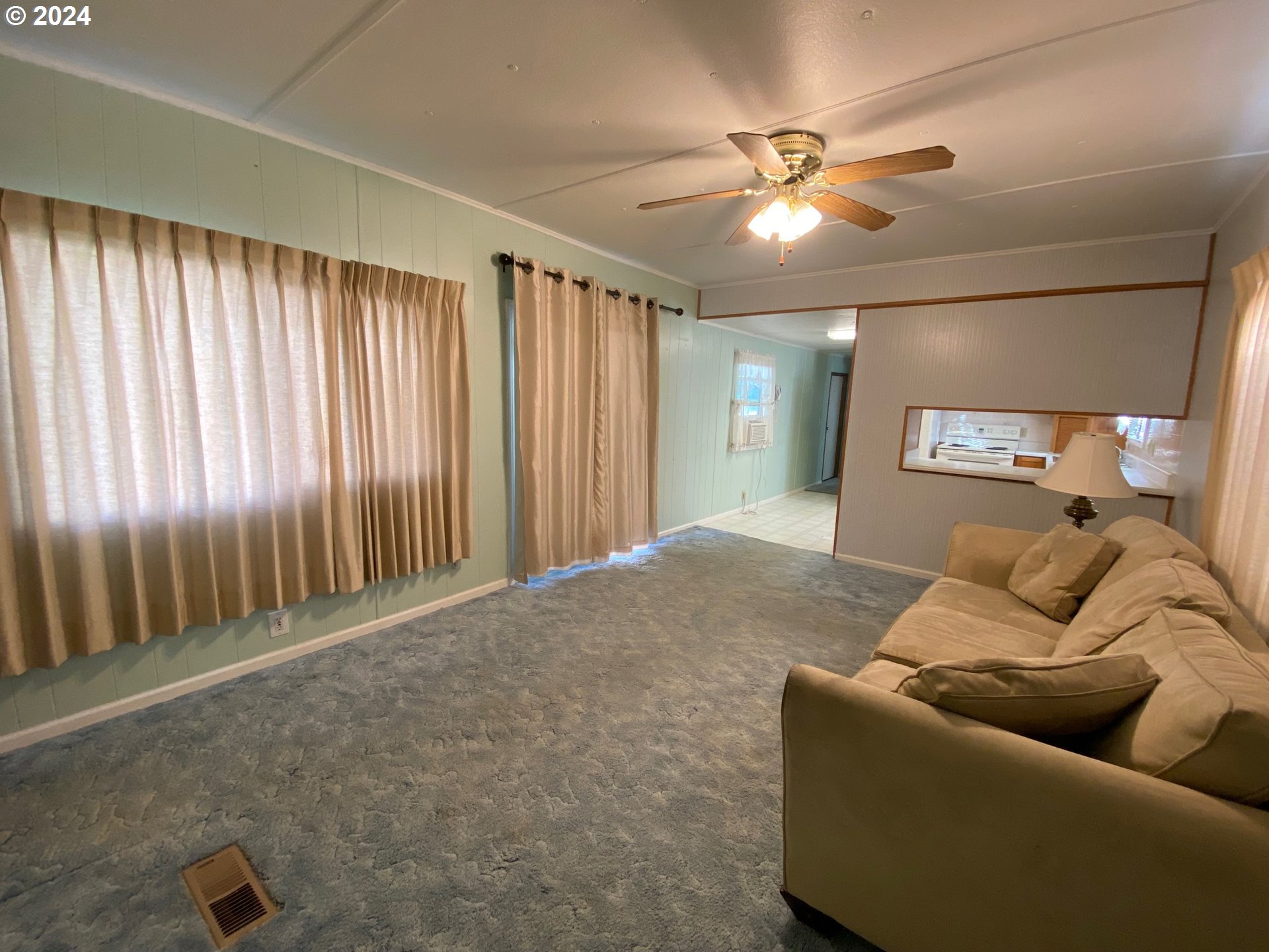 3950 Coburg Road, Unit 82 Eugene, OR 97408 - Photo 16 of 22 a living room with furniture and a ceiling fan