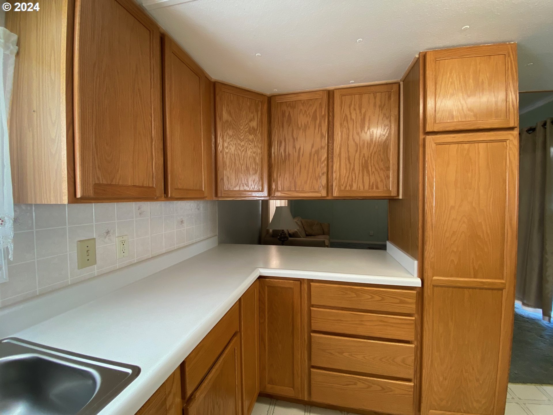 3950 Coburg Road, Unit 82 Eugene, OR 97408 - Photo 10 of 22 a kitchen with a refrigerator and a sink