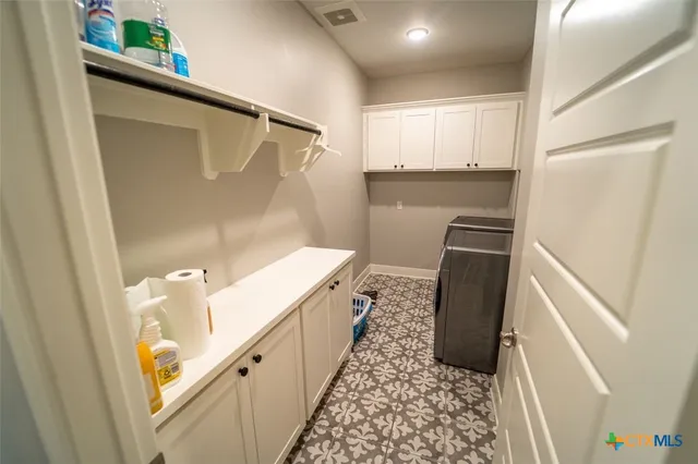 a kitchen with granite countertop a refrigerator and a sink