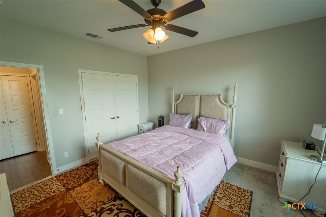 113 Terra Vista Ranch Road Victoria, TX 77904 - Photo 15 of 27 a bedroom with a bed and a table in it