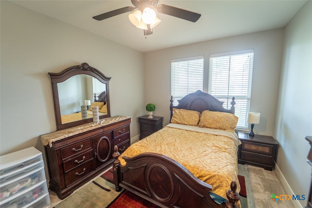 113 Terra Vista Ranch Road Victoria, TX 77904 - Photo 16 of 27 a bedroom with a bed and a mirror on the dresser