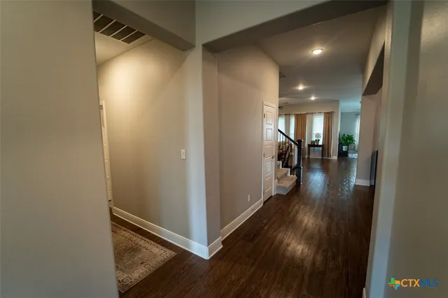 a view of hallway with wooden floor