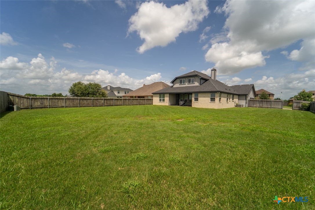 113 Terra Vista Ranch Road Victoria, TX 77904 - Photo 27 of 27 a view of a big yard with table and chairs under an umbrella