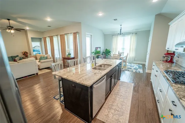 a large kitchen with granite countertop lots of counter top space