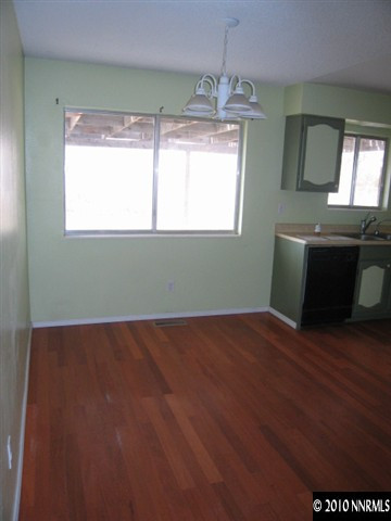 1517 Red Road Fallon, NV 89406 - Photo 4 of 13 a view of an empty room with wooden floor and a window