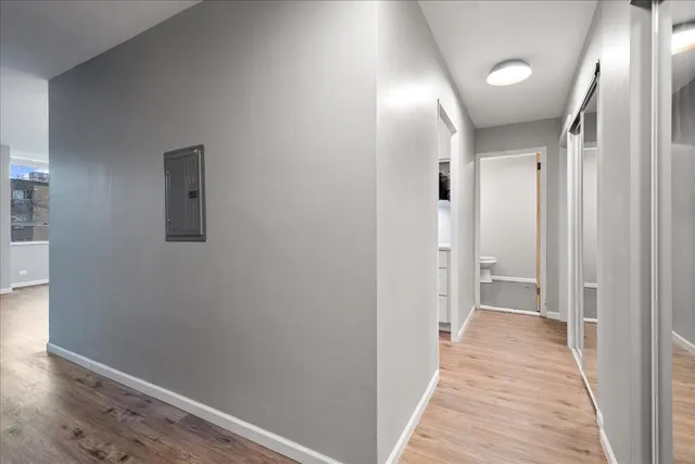 a view of a hallway with wooden floor
