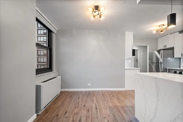 a view of a kitchen cabinets a sink and wooden floor