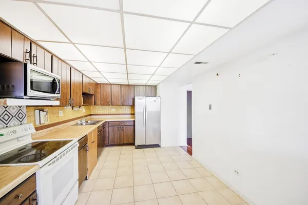 a kitchen with a stove sink and cabinets