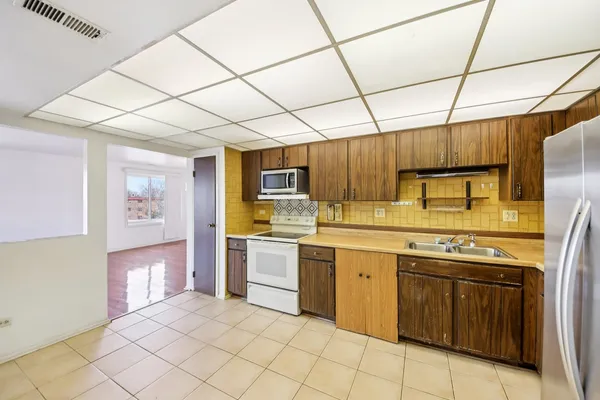 a kitchen with a sink and cabinets