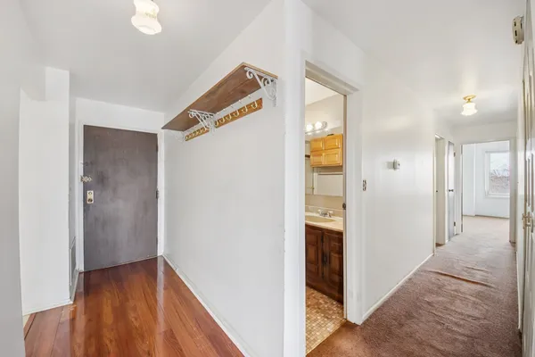 a bathroom with a granite countertop toilet a sink and mirror