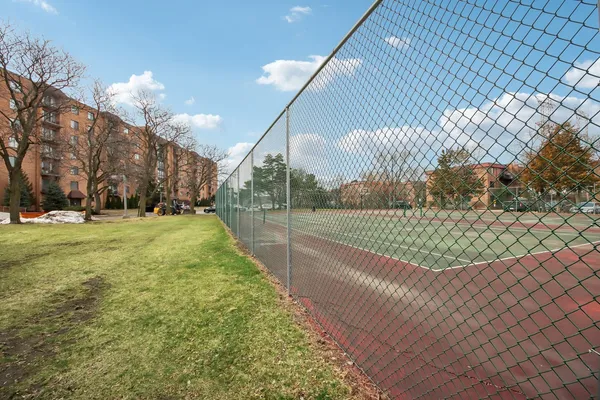 a picture of a room with a white wall and a refrigerator