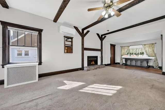 a view of empty room with a fireplace