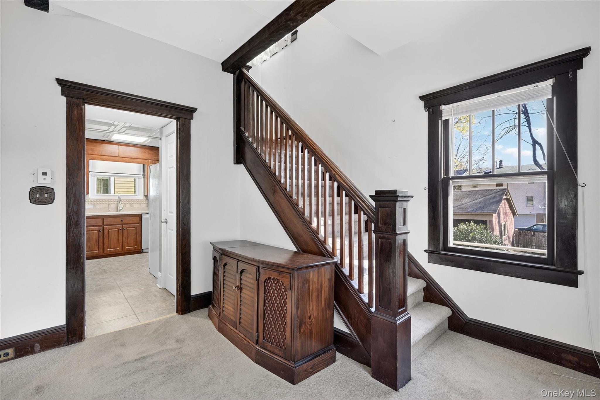 165 Wayne Avenue Suffern, NY 10901 - Photo 17 of 38 Staircase featuring carpet floors, beamed ceiling, and tile patterned floors