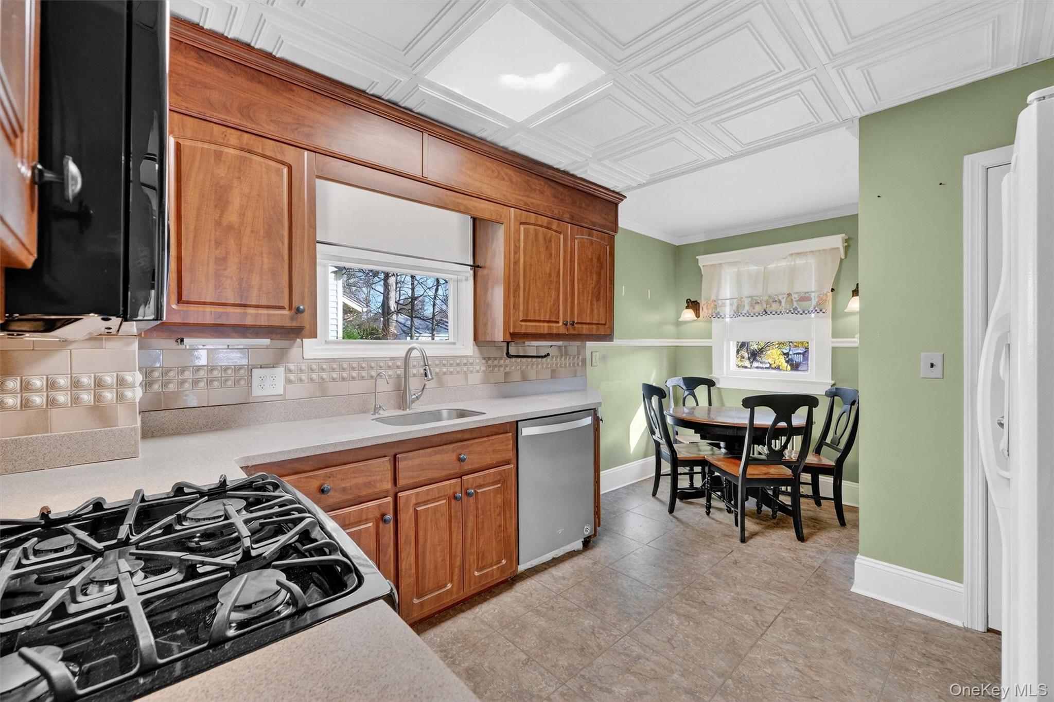 165 Wayne Avenue Suffern, NY 10901 - Photo 19 of 38 Kitchen with black appliances, plenty of natural light, brown cabinets, light countertops, and an ornate ceiling
