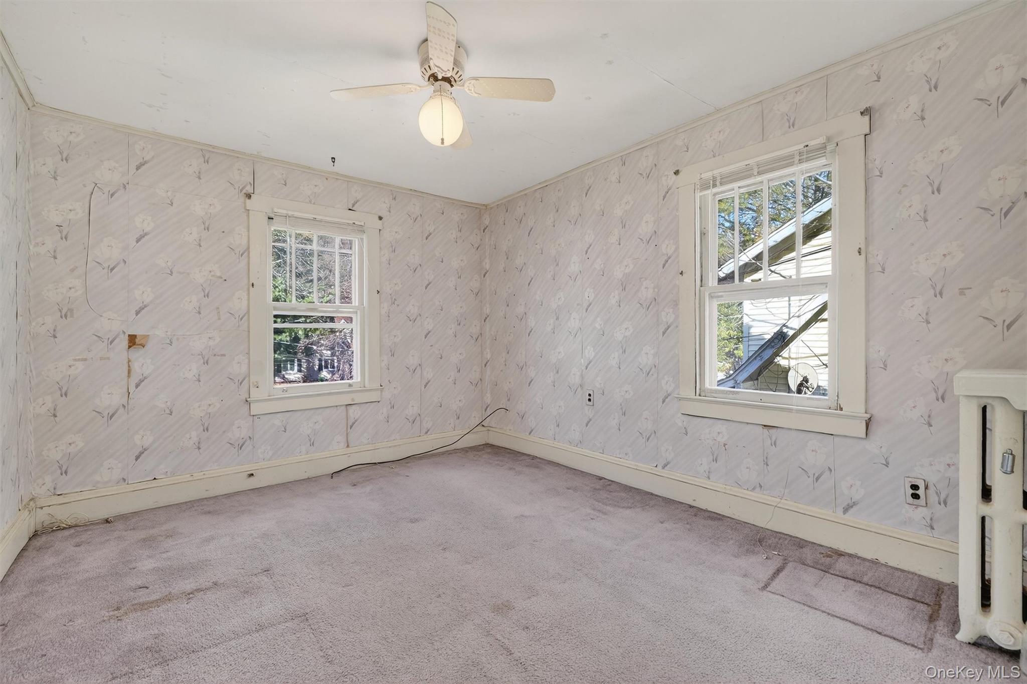 165 Wayne Avenue Suffern, NY 10901 - Photo 28 of 38 Empty room featuring healthy amount of natural light, carpet floors, wallpapered walls, and ceiling fan