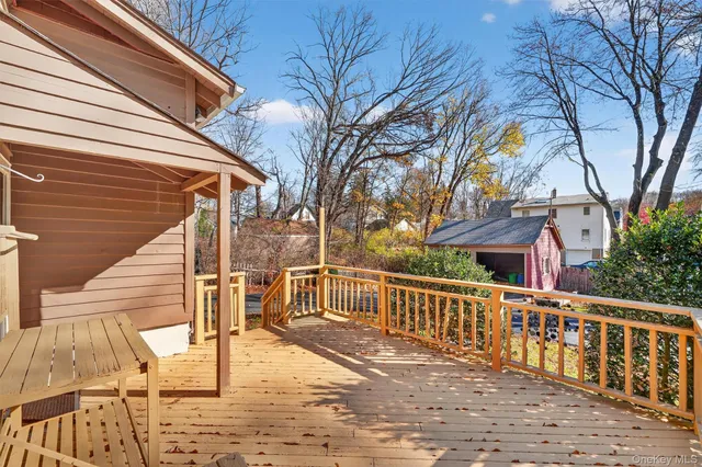 a view of a house with wooden deck