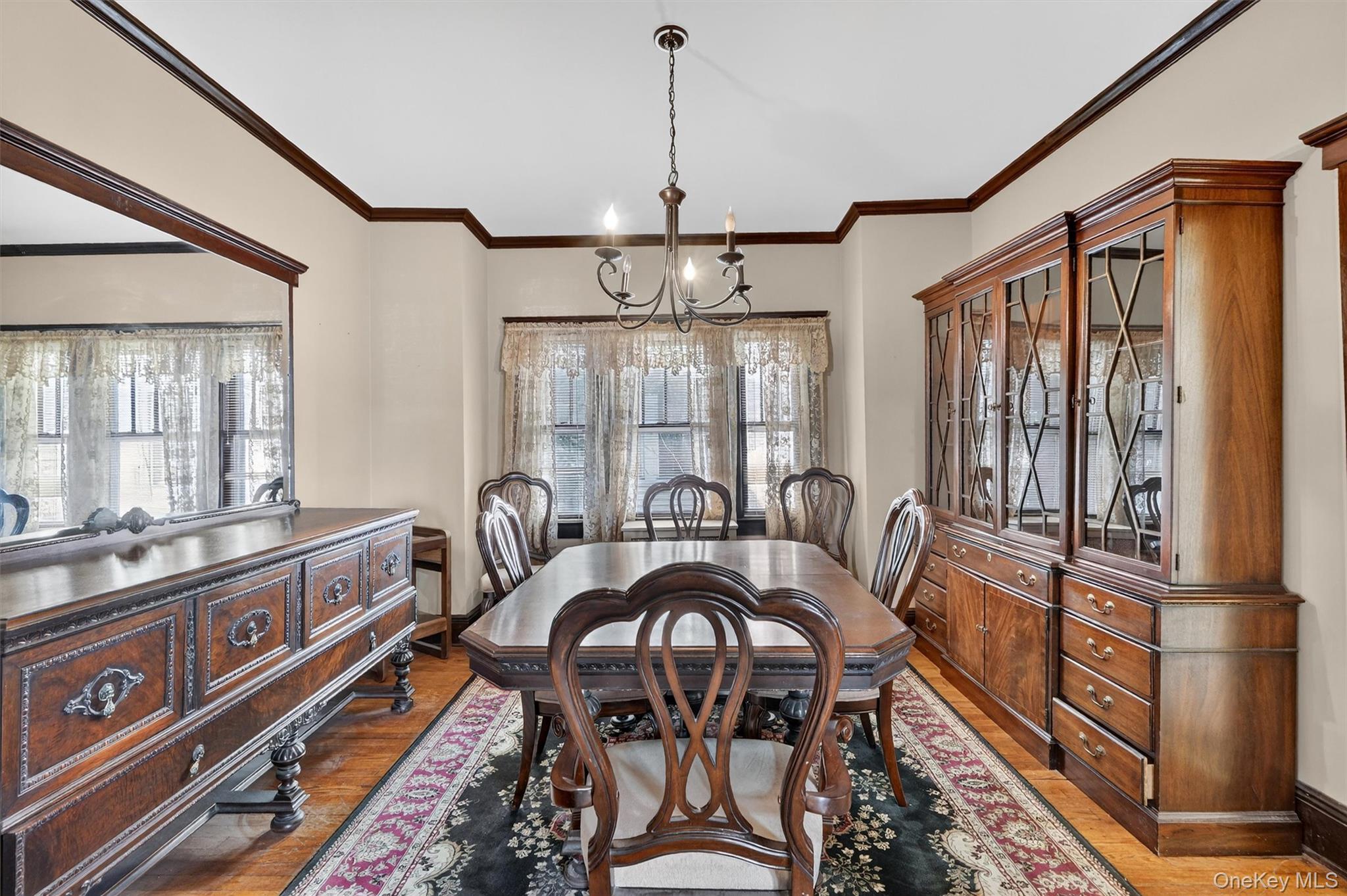 165 Wayne Avenue Suffern, NY 10901 - Photo 3 of 38 Dining space featuring light wood-style floors, crown molding, a chandelier, and plenty of natural light