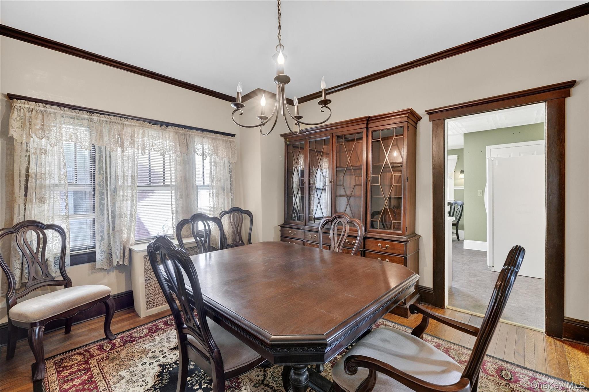 165 Wayne Avenue Suffern, NY 10901 - Photo 4 of 38 Dining area with ornamental molding, wood finished floors, and a chandelier