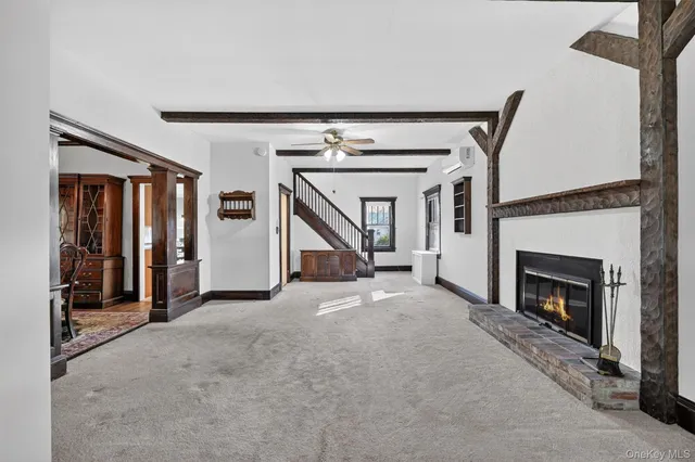 a view of a livingroom with an empty space and a fireplace