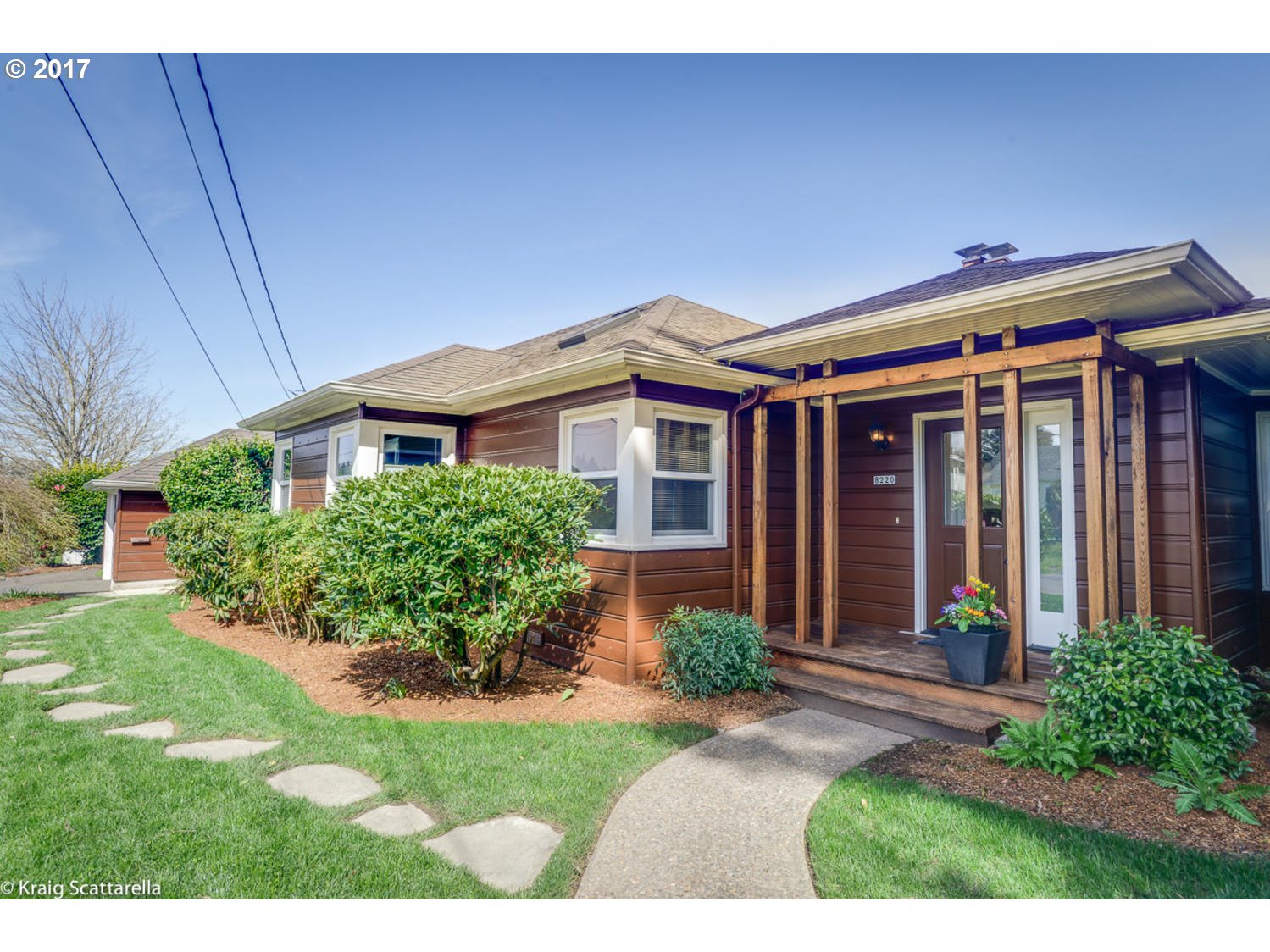 8220 Southwest 3rd Avenue Portland, OR 97219 - Photo 1 of 32 a front view of a house with a yard