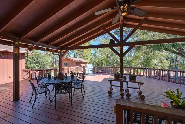 an aerial view of residential house with outdoor space and trees all around