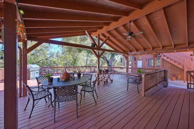 a view of a balcony with wooden floor and fence