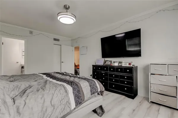 a bedroom with a bed and a flat screen tv