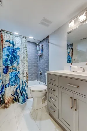 a bathroom with a double vanity sink mirror and toilet