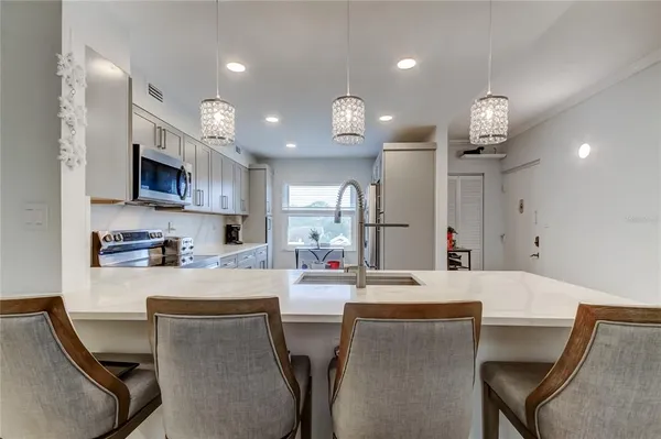 a large kitchen with a table and chairs