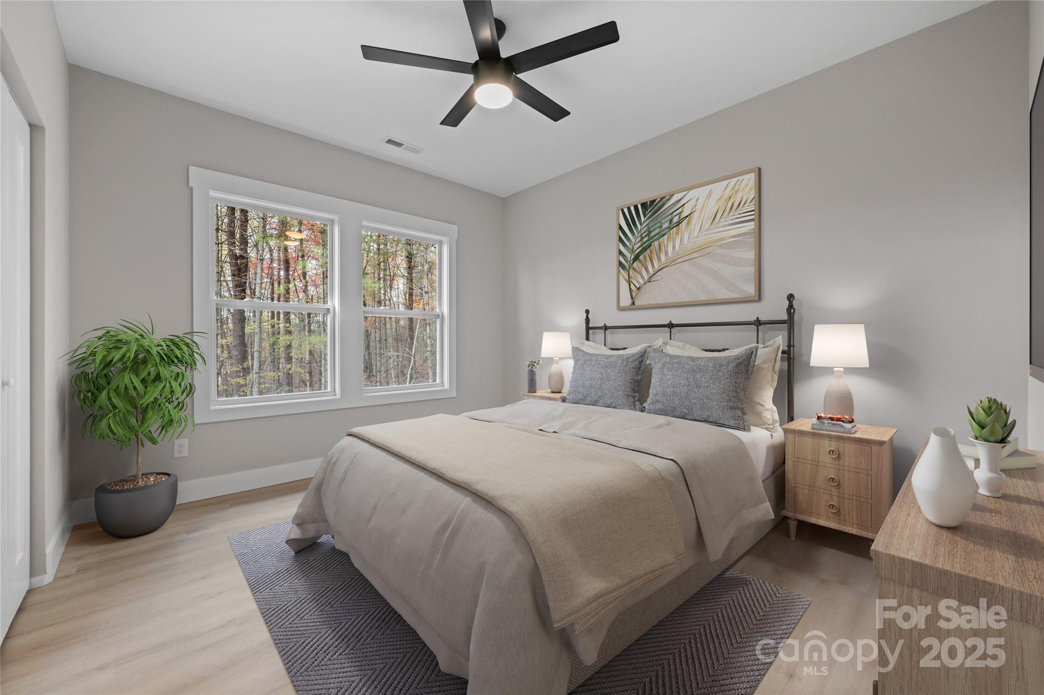 446 Old Buckeye Cove Road Swannanoa, NC 28778 - Photo 38 of 48 a bedroom with a bed and ceiling fan