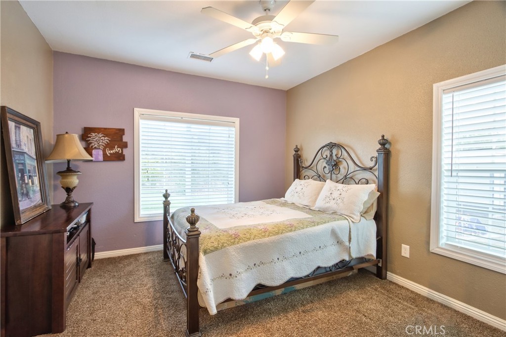 40105 Voyager Road Hemet, CA 92544 - Photo 11 of 27 a bedroom with a bed desk and a window